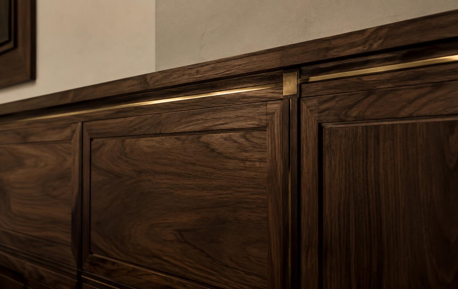 Walnut millwork paneling with inset brass detailing